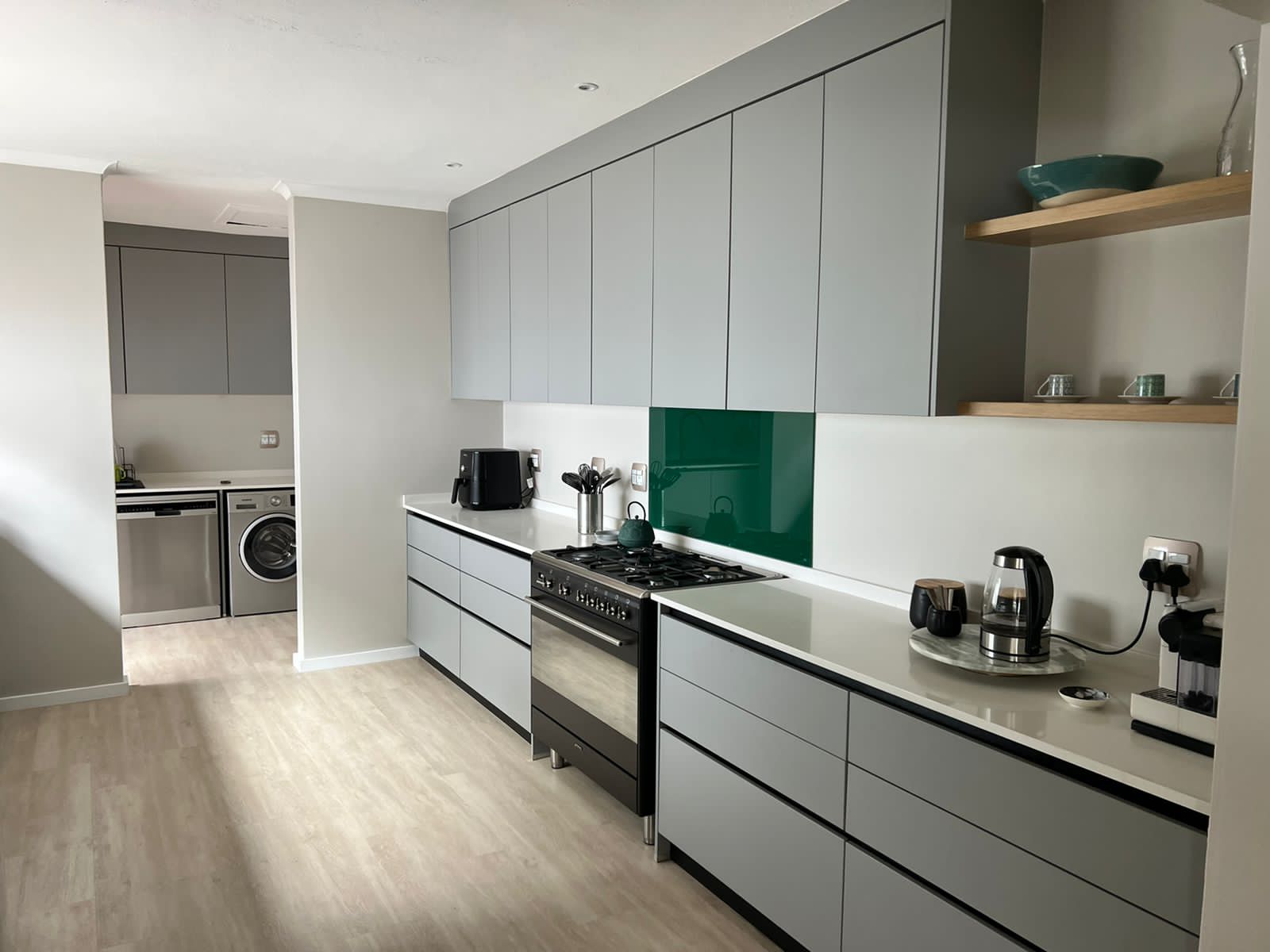 Modern open-plan kitchen and living space featuring custom cabinetry